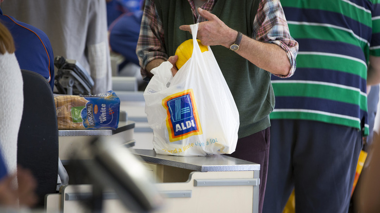 Person bagging groceries at Aldi