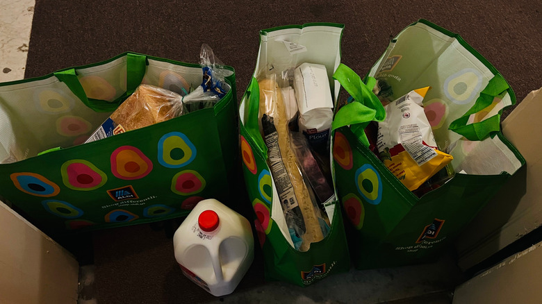 Reusable Aldi bags full of groceries on floor