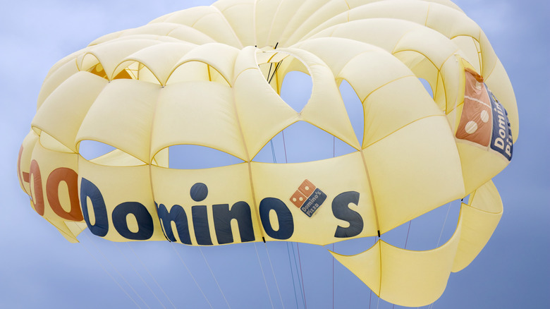 Domino's parachute in sky