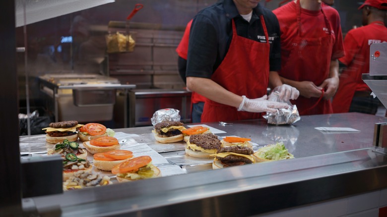 Five Guys assembly line employees making burgers