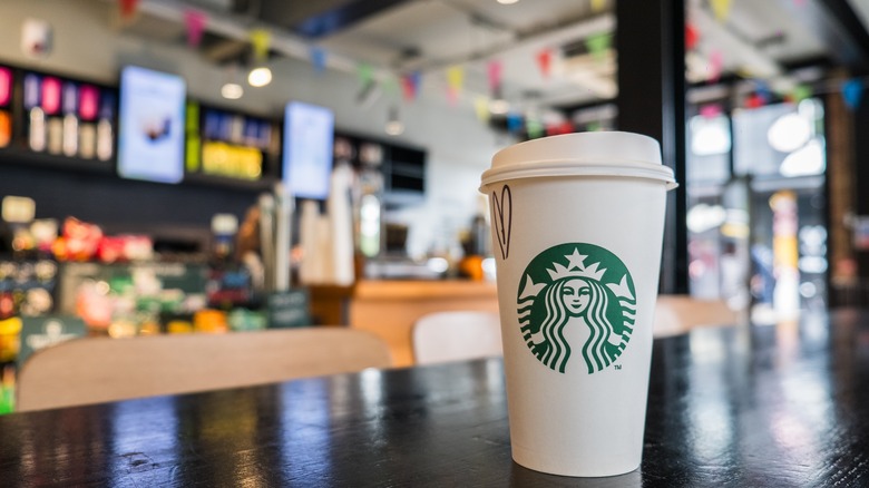 White Starbucks takeaway cup on table