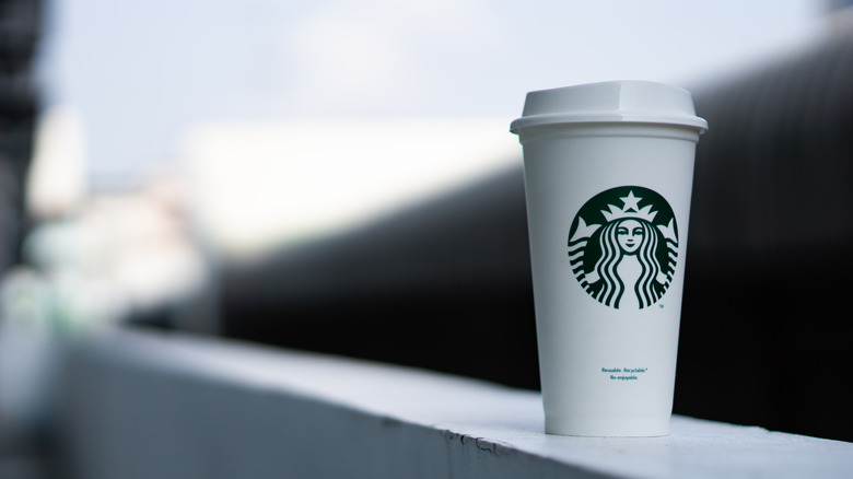 A disposable starbucks coffee cup