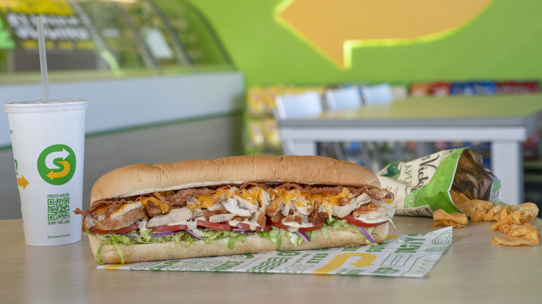 Subway sandwich with drink and chips