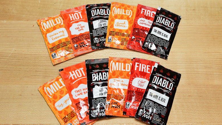 Different Taco Bell sauce packets on a table