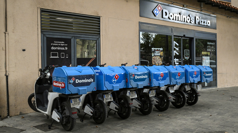 Line of Domino's delivery bikes outside Domino's in France