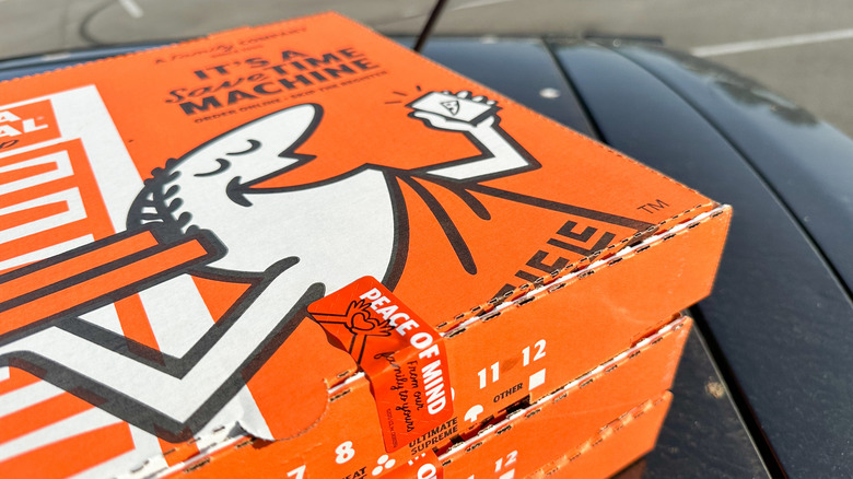 Three Little Caesars pizza boxes