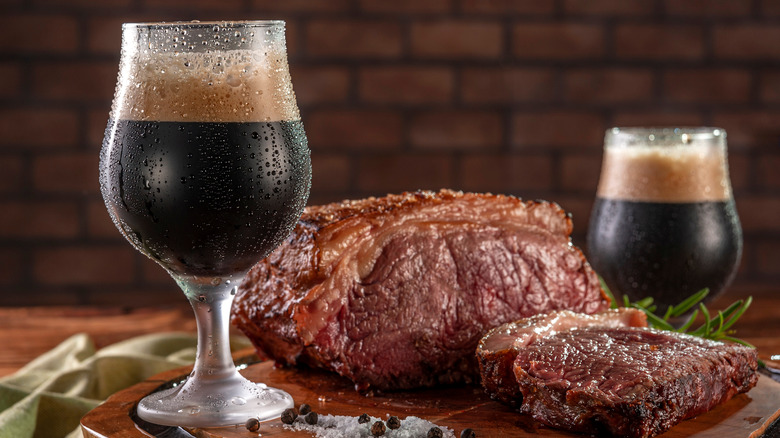 steak and dark beer in glass