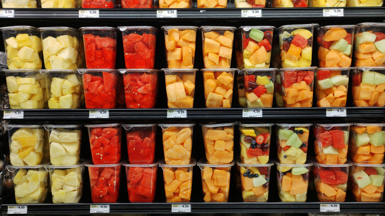 Various pre-cut fruits on store shelf