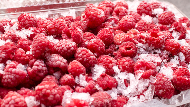 pile of raspberries on ice