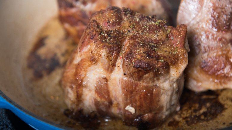 pork shoulder browning in skillet