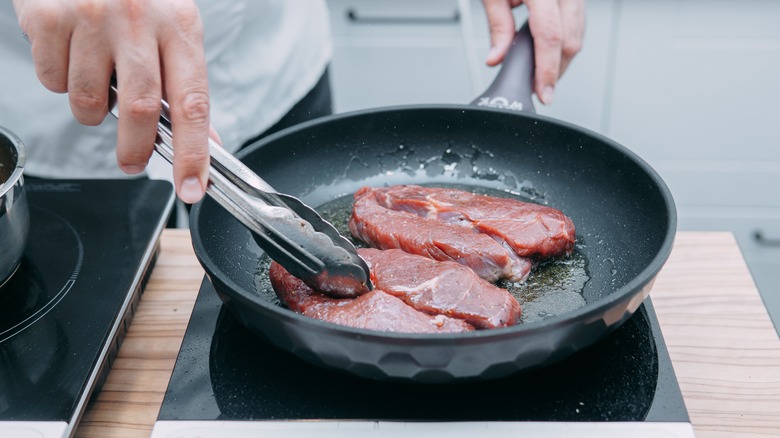 searing steak in a pan