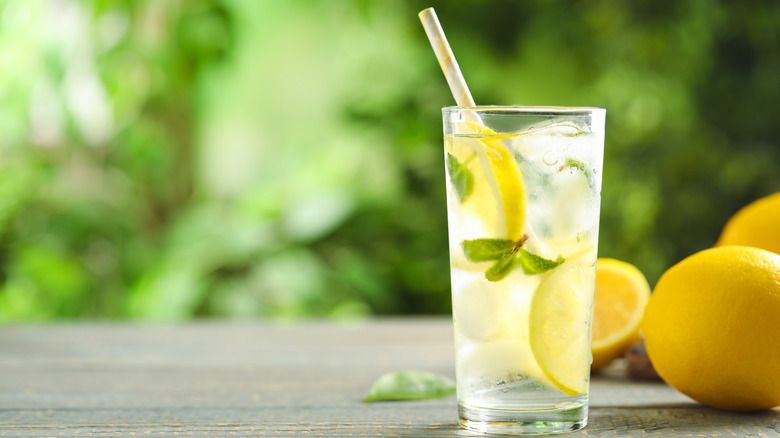 cold lemon water with mint and whole lemons