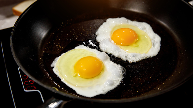 two fried eggs in pan