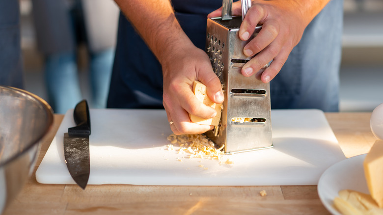 grating cheese hands knife