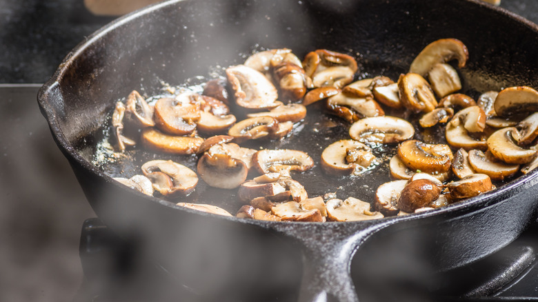 sautéed mushrooms cooking in pan