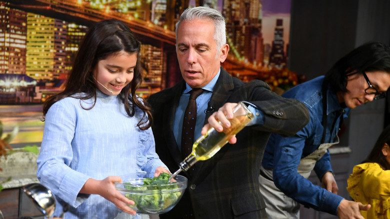 Geoffrey Zakarian cooking with a young girl