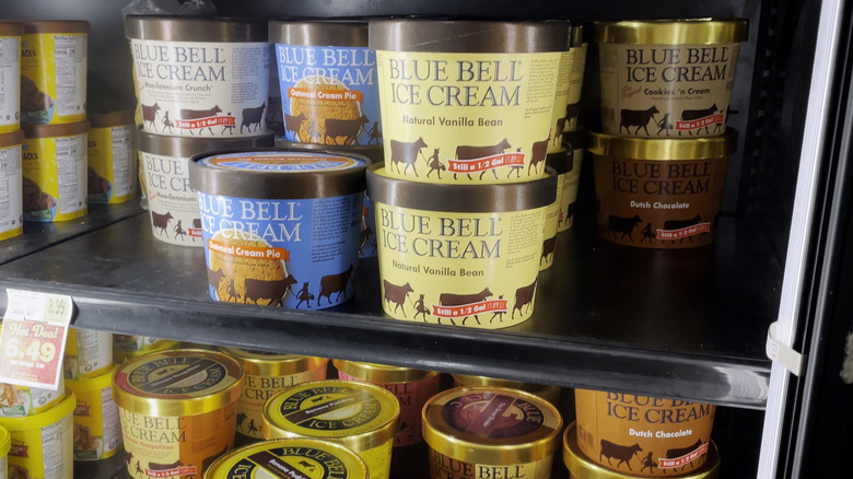 Blue Bell ice cream tubs in a grocery store freezer