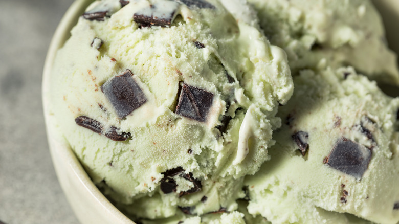 Scoops of mint chocolate chip ice cream in bowl