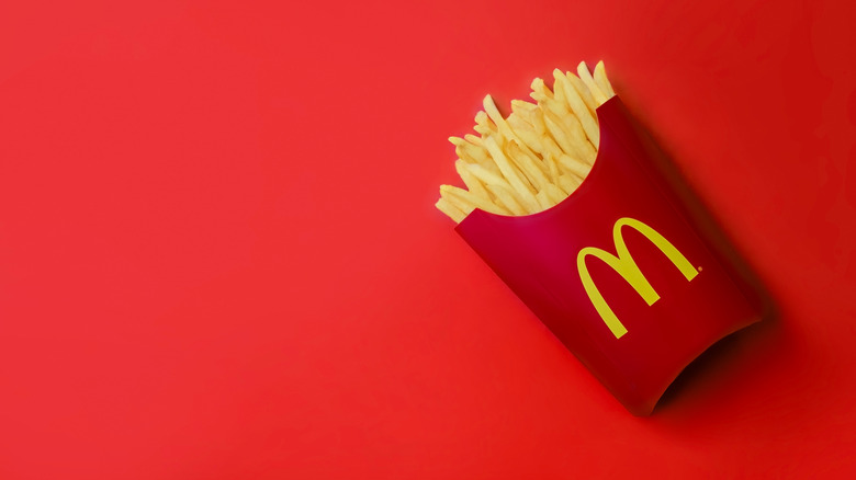 Box of McDonald's fries on red background