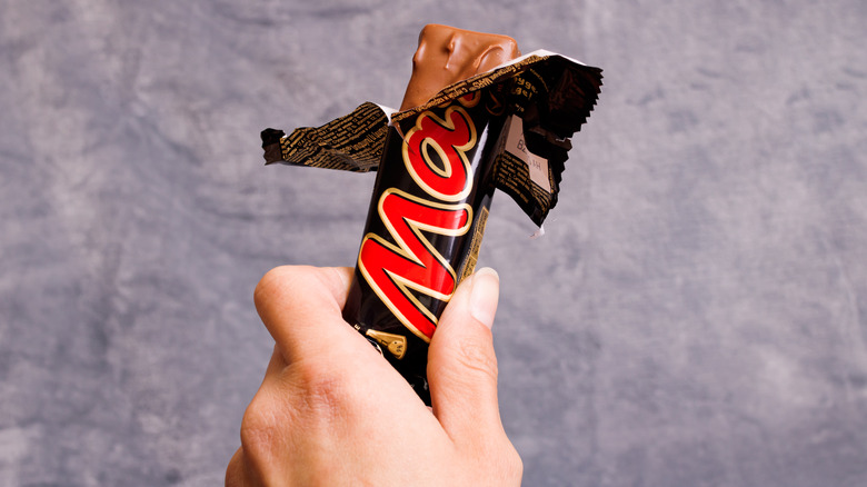 Hand holding a Mars bar