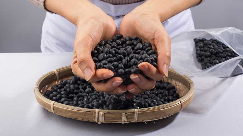 handful black beans over basket