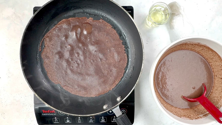 chocolate crepe cooking in pan