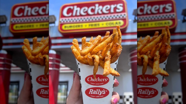 Person holding Checkers seasoned fries