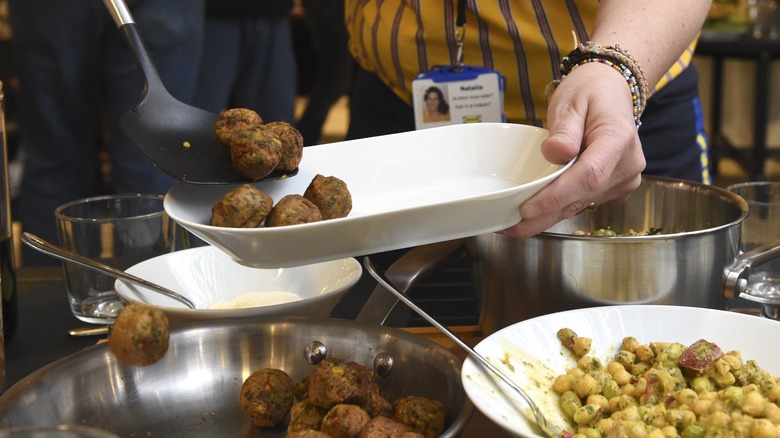 Person plating IKEA meatballs