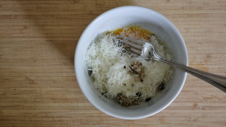 bowl of egg, cheese, and grated truffle