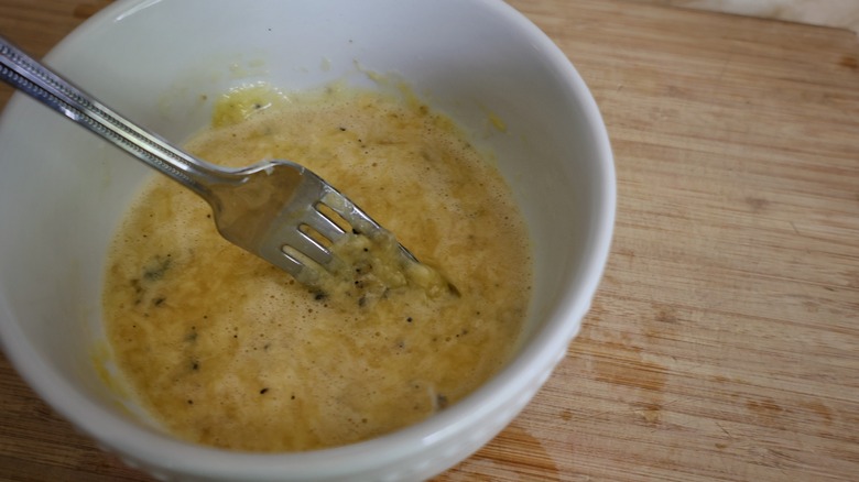 bowl of whisked eggs and cheese