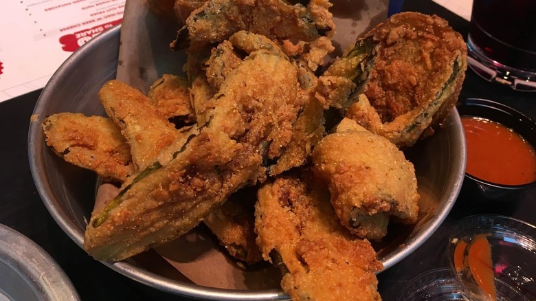 seasoned fried pickles in a metal bowl