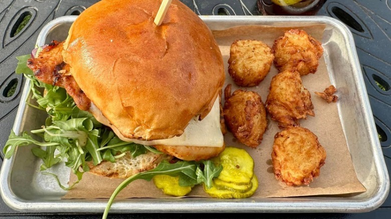 platter with grilled chicken sandwich, tots