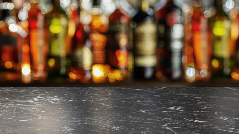 empty bar counter with bottles in background