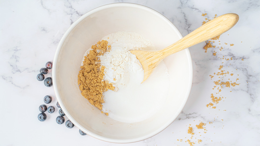 mixing dry ingredients for blueberry muffins