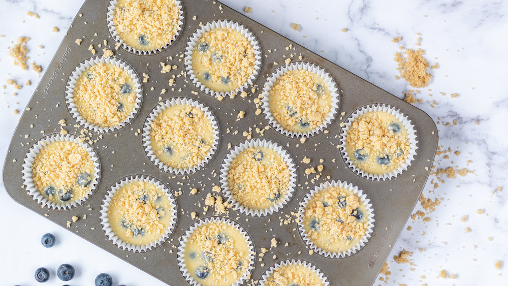 blueberry muffin batter in tins