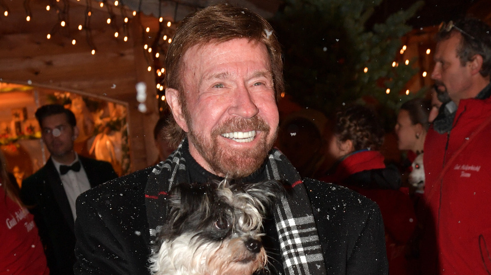 Chuck Norris holding dog