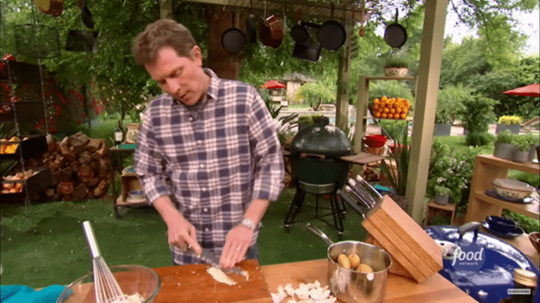 Bobby Flay chopping garlic