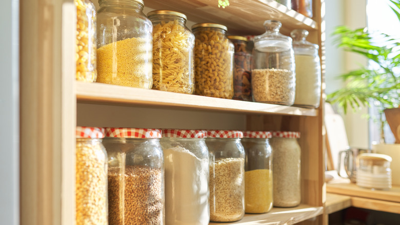 glass jars full of grains in pantry