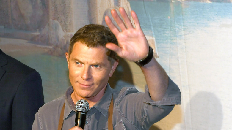 Bobby Flay waving his hand 