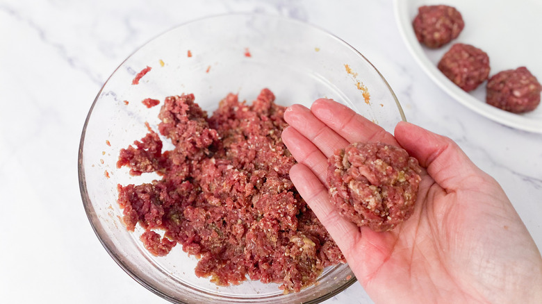 hand rolling meatballs