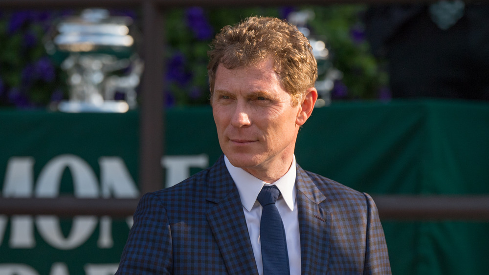 bobby flay standing outside in suit