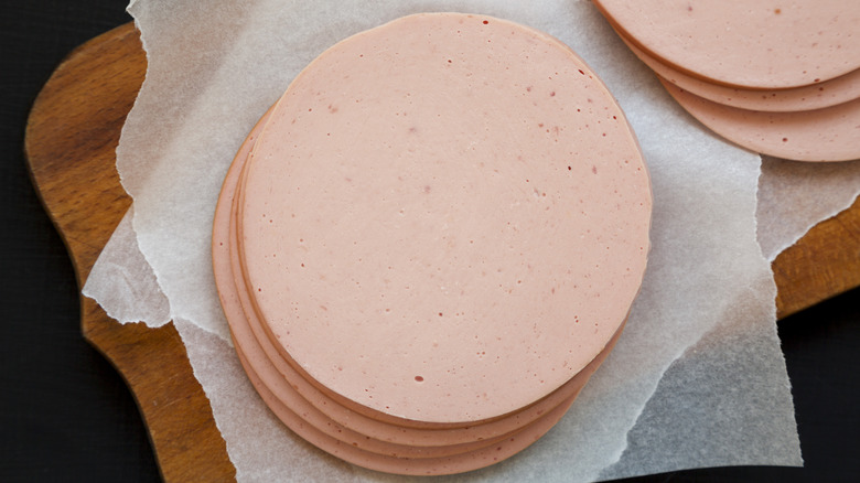 Sliced bologna on cutting board