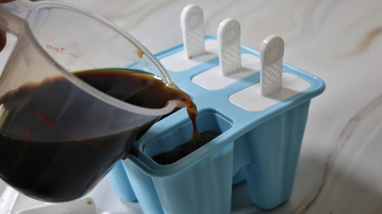 pouring espresso martini into popsicle mold