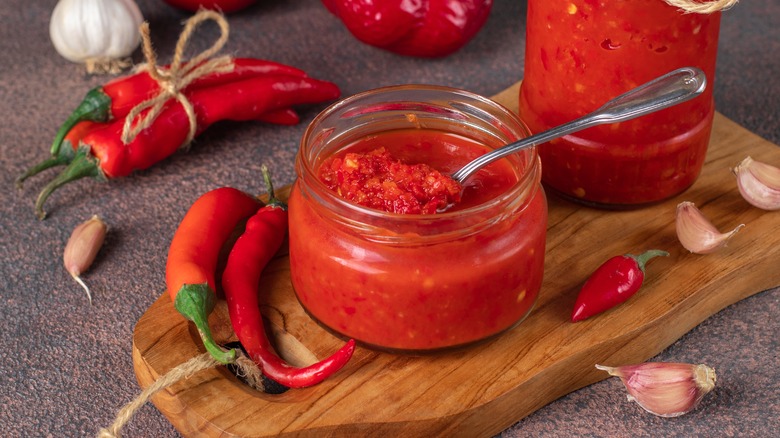 Jar of hot sauce with peppers