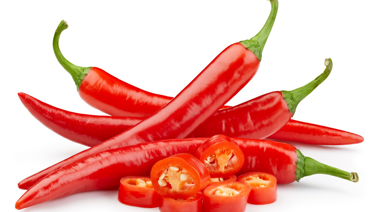 Red chilis against white background