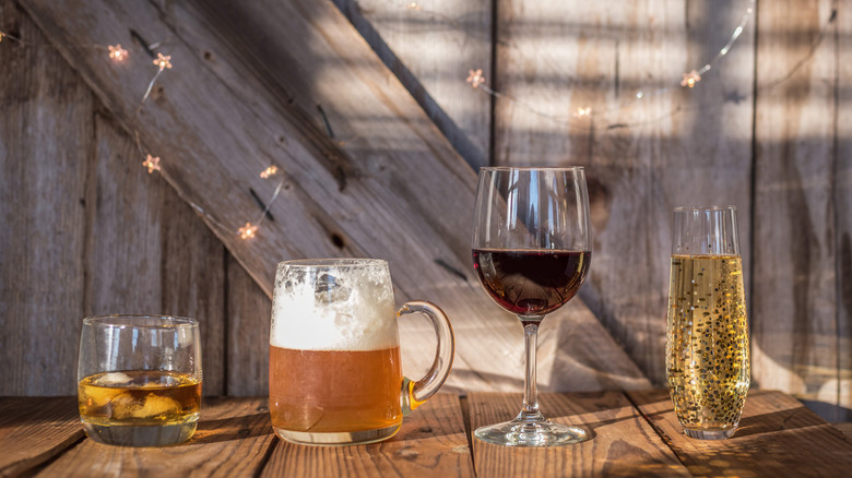 Bourbon, beer, wine, and champagne on wood table