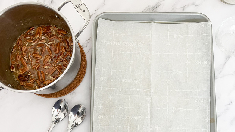 lined baking sheet and praline mixture