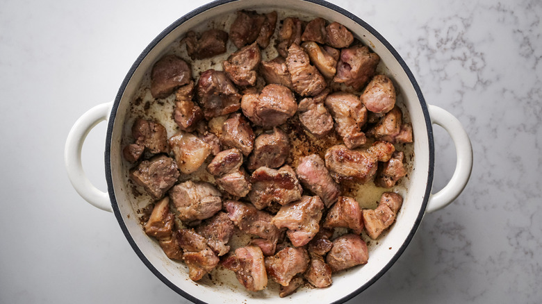 pork browning in Dutch oven