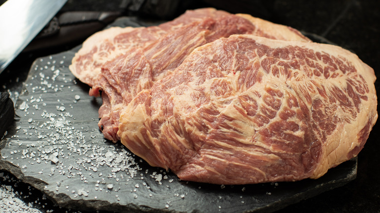 raw cupim or beef hump steak on slate stone