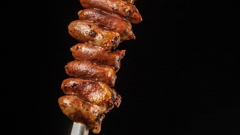 chicken hearts on skewer with black background